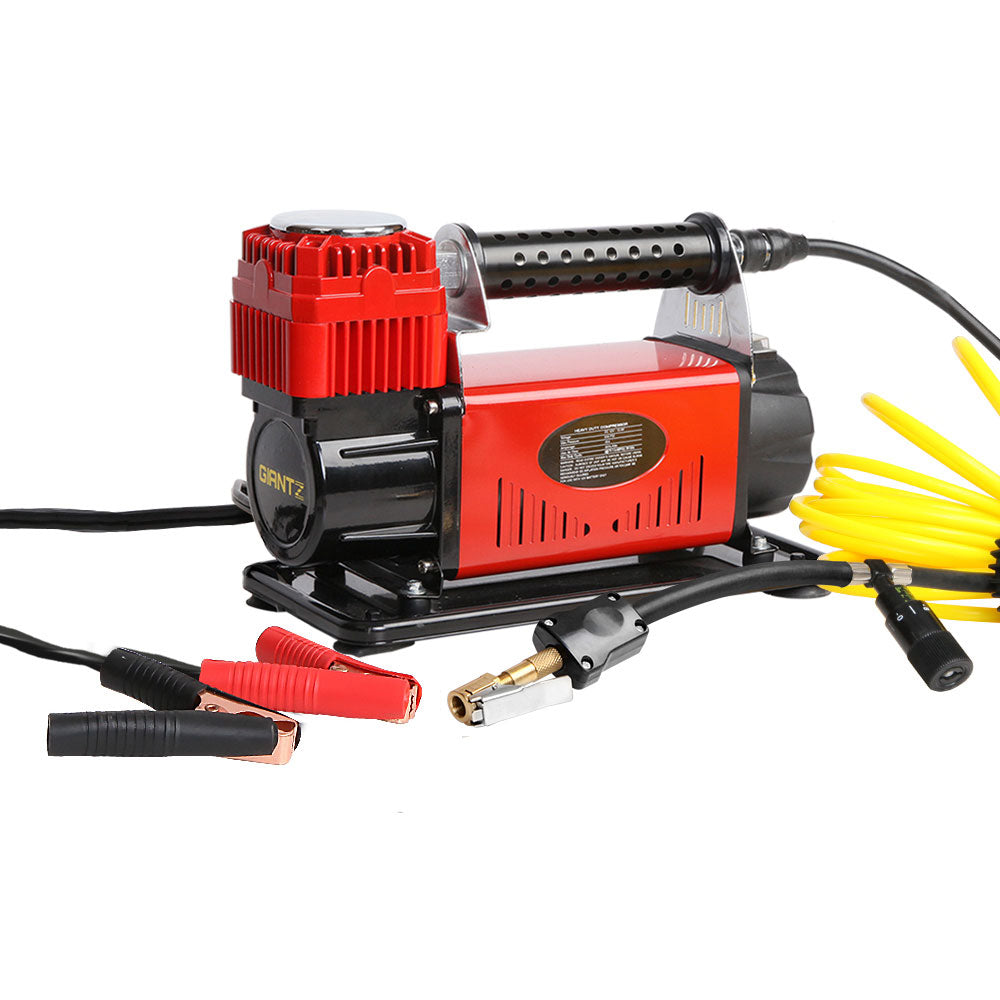 A Giantz Air Compressor 12V 4x4 Tyre 320L/min Deflator Inflator Car Truck Portable with a red and black exterior sits beside a yellow coiled hose and red and black alligator clips. Labeled "GRITZ," it boasts a 540W motor, accurate pressure gauge, and various nozzles and connectors, highlighting its versatility.