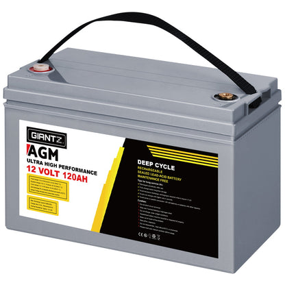 A gray deep cycle 120Ah 12V battery labeled "Giantz AGM Deep Cycle Battery 12V 120Ah Box Portable Solar Caravan Camping" is pictured in front of a black battery box. Featuring AGM technology, the battery has a handle on top for easy carrying. Text and safety symbols are visible on the label, highlighting its deep discharge recovery capability.