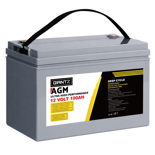 A gray rectangular 12-volt 100AH deep cycle battery with AGM technology and a black carrying handle on top. The label indicates it is a Giantz AGM Deep Cycle Battery 12V 100Ah Box Portable Solar Caravan Camping. The battery also features technical specifications and usage details in yellow and black text, ideal for off-the-grid power supply.