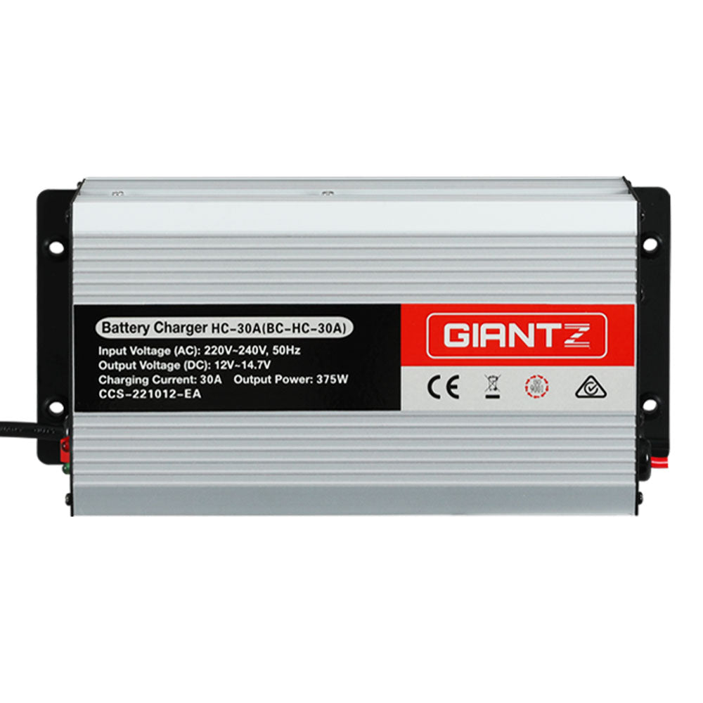 A silver and black battery charger labeled "Giantz 12V 30A Car Battery Charger 30Amp ATV 4WD Boat Caravan" with model number HC-30A(BC-HC-30A) is designed for 12V batteries. It showcases input voltage (AC: 220V-240V, 50Hz), output voltage (DC: 12V-14.7V), charging current (30A), and output power (375W).