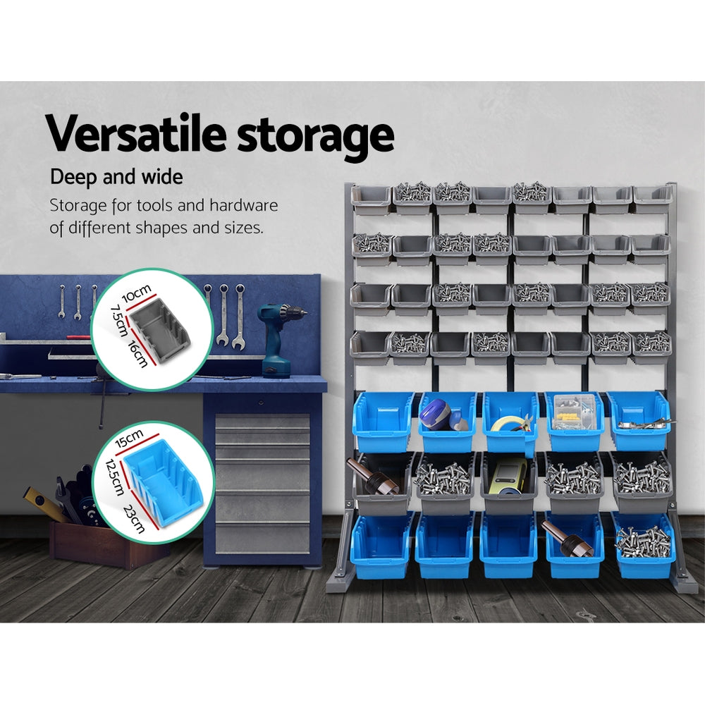 An organization setup featuring a Giantz 47 Storage Bin Rack Wall Mounted Steel Stand with multiple gray and blue bins filled with various screws and hardware. Tools and a drill are visible on a workbench with drawers beneath. A magnetic tool bar holds essentials, while text states "Versatile storage" and highlights bin dimensions.