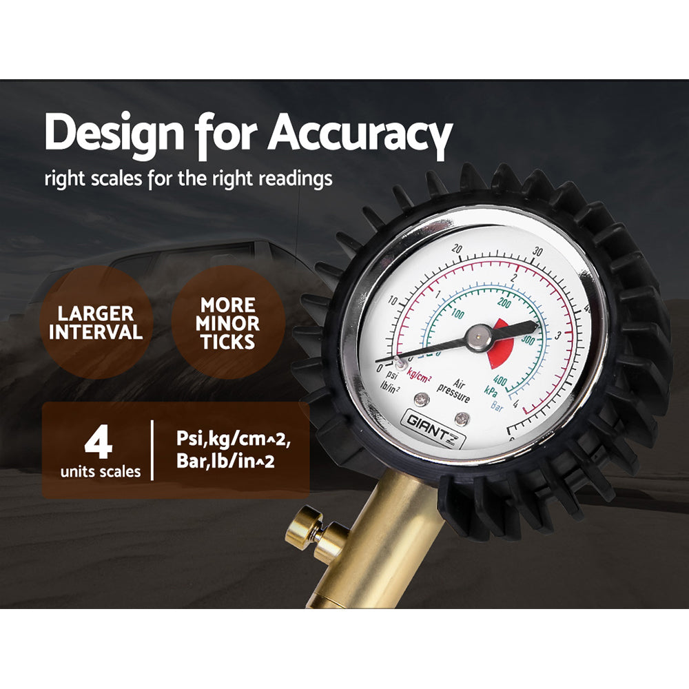 A Giantz 4X4 4WD Gauge Valve Rapid Tyre/Tire Deflator with a black rubber hose and brass fittings is shown. The gauge has a dial with measurements and a protective black rubber cover. Four black valve caps are lined up next to it, making it an essential off-road tool for precise tire management.