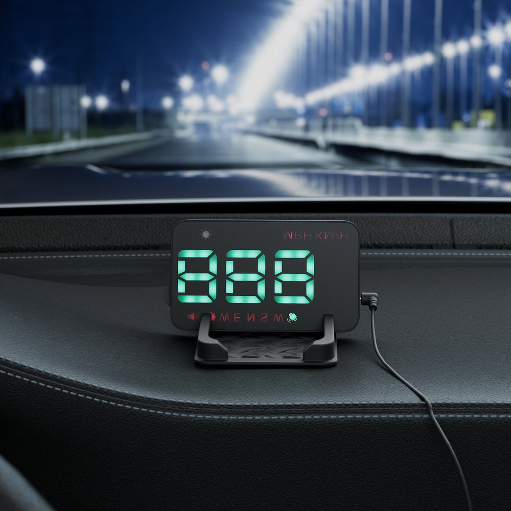 A black Giantz Universal Car Digital GPS Speedometer HUD Display Overspeed Warning Alarm 2 Modes with green LED numbers displayed upside down, reflected on the stand. The clock features icons for brightness adjustments and a red temperature display at the top, resembling a GPS HUD speedometer. A power cord is plugged into the side of the clock's stand.