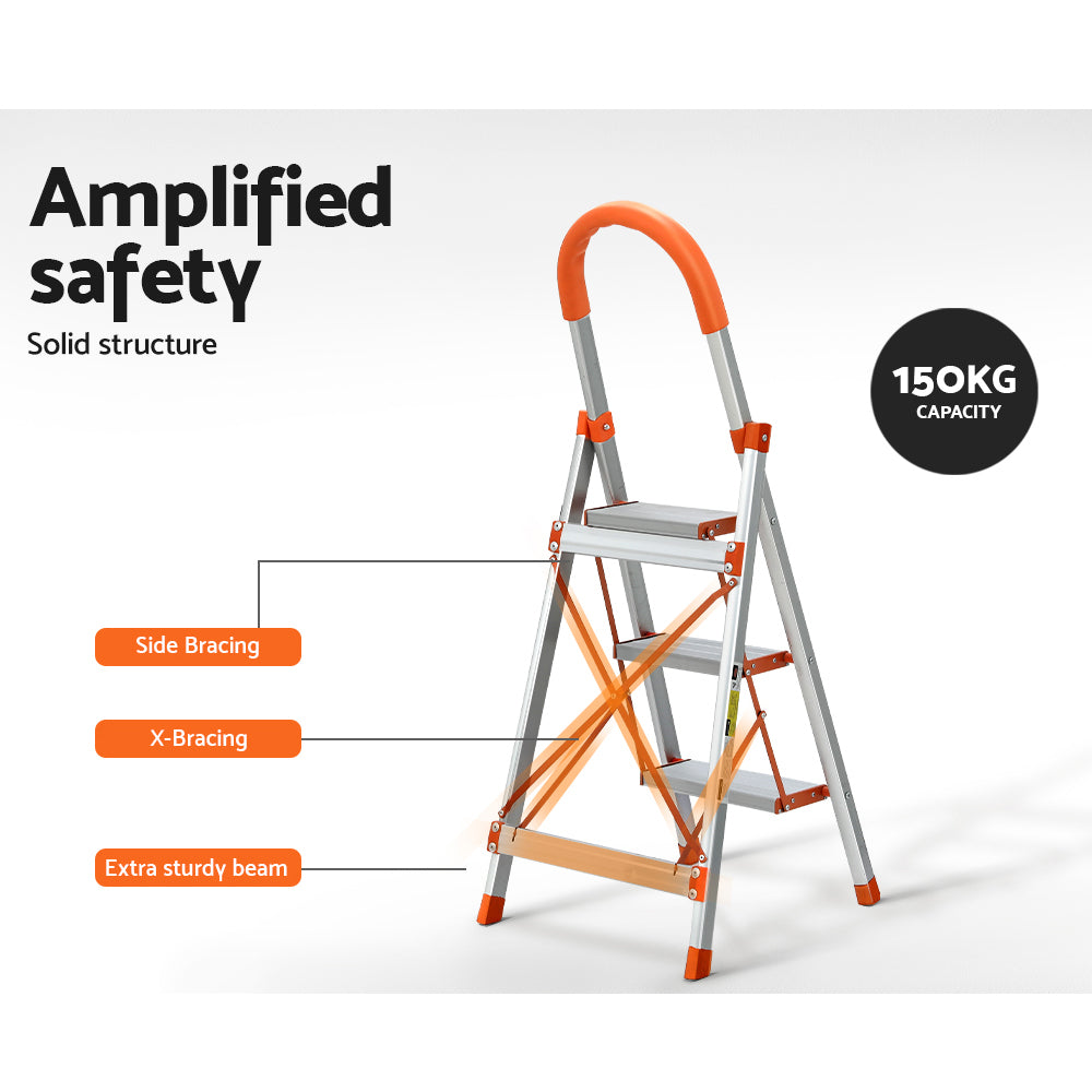 A Giantz 3 Step Ladder Multi-Purpose Folding Aluminium Light Weight Non Slip Platform, accented with orange on the steps, top railing, and foot pads. Designed for indoor use, it features non-slip rubber feet for stability and a handle at the top for added safety.