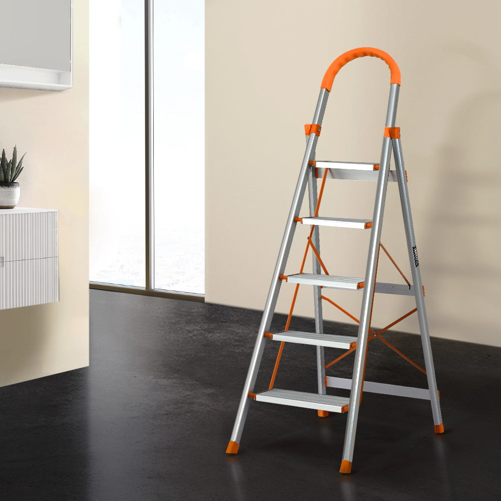 A Giantz 5 Step Ladder Multi-Purpose Folding Aluminium Light Weight Non Slip Platform with five wide steps and orange accents on the top handle, edges of the steps, and support braces. This lightweight aluminum ladder is open, standing on a white background, and features non-slip rubber feet for added stability.