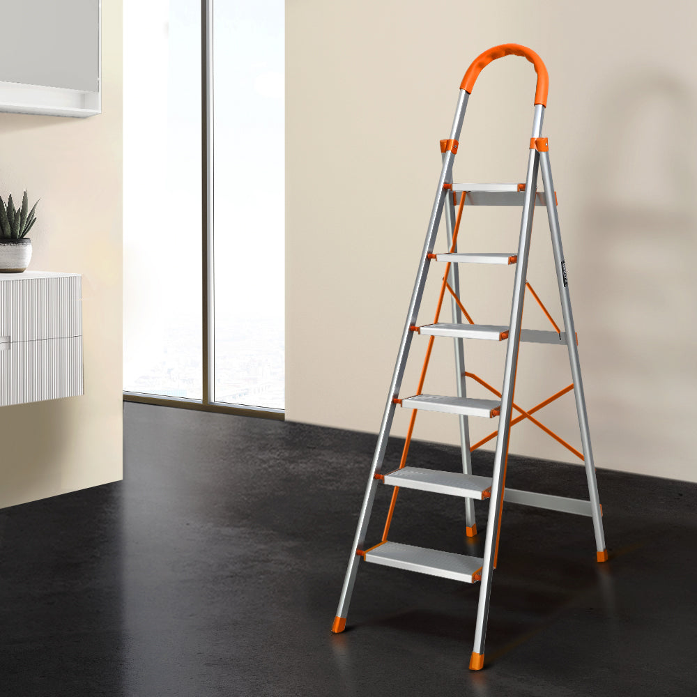 A Giantz 6 Step Ladder Multi-Purpose Folding Aluminium Light Weight Non Slip Platform with five steps, orange accents on the top handle, step edges, and non-slip rubber feet. It features a sturdy, lightweight aluminum frame, additional support braces for stability, and a foldable design for easy storage.