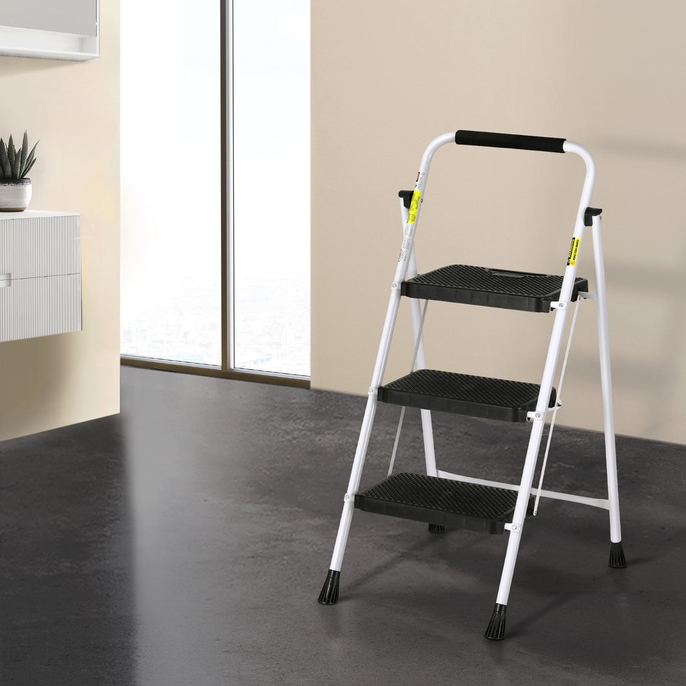 A Giantz 3 Step Ladder Multi-Purpose Folding Steel Light Weight Platform with a white lightweight steel frame and black non-slip steps. The top handle has a padded black grip, and the legs have black rubber feet for stability and protection against slipping.