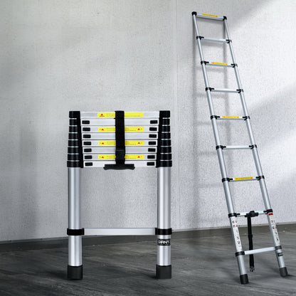 A collapsible Giantz 2.6M Telescopic Ladder Aluminium Extension Extendable Steps Adjustable Height is seen in both its extended and compact forms. The extended ladder, made from premium aluminum alloy, shows multiple rungs with safety labels. The compact version is neatly folded with securing straps and anti-slip end caps for stability.