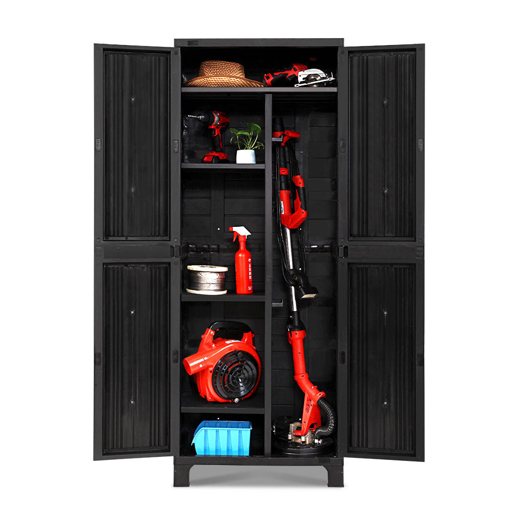 A black Gardeon 173cm Outdoor Storage Cabinet Box Lockable Cupboard Sheds Garage Adjustable reveals organized, adjustable shelves. Inside are red power tools, a small plant, a hat, cleaning supplies, a hose reel, and a box. The weather-resistant cabinet houses items like a handheld vacuum and hedge trimmer among other assorted gear.