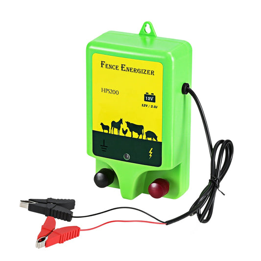 A green and yellow battery-powered Electric Fence Energiser labeled "Giantz 18km Electric Fence Energiser 1.56J" features images of livestock on it. The device includes a power indicator and two knobs. Attached are black and red cables with alligator clips for connection, ensuring reliable livestock protection.