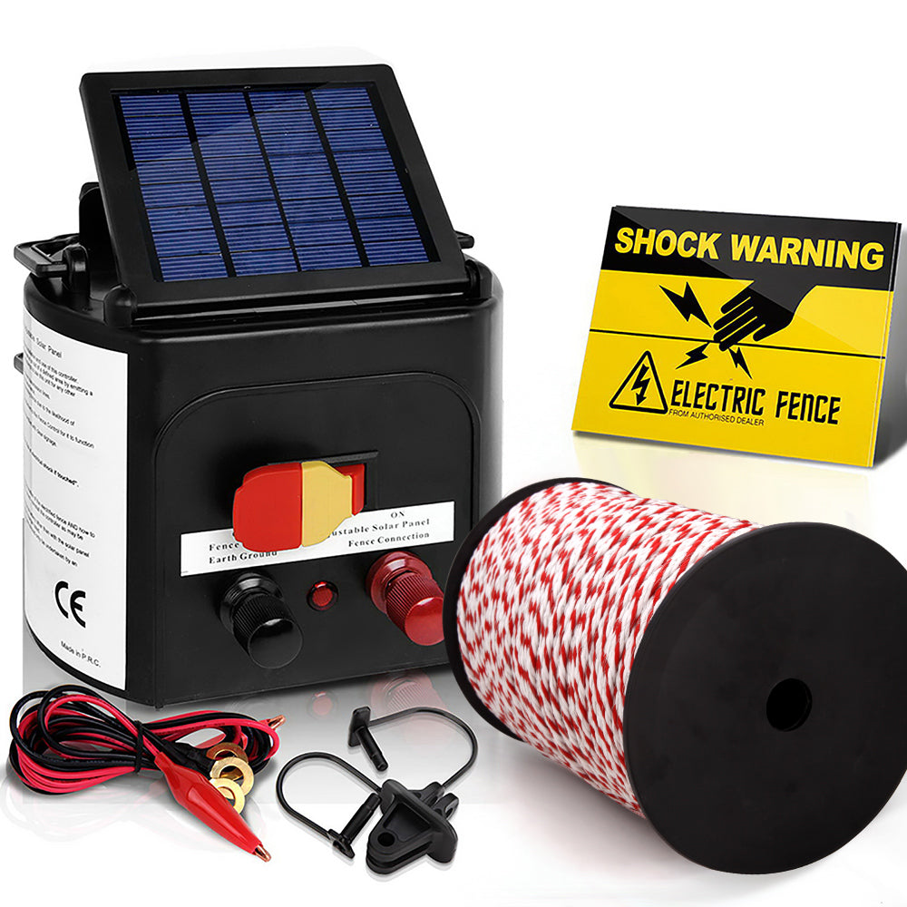 A Giantz Fence Energiser 3KM Solar Powered Electric 500M Poly Rope with a black and red fence energiser unit featuring a solar panel on top, red and black connectors, and an on/off switch. Included are a roll of red and white wire, a set of connectors and cables, and a yellow "Shock Warning" sign for effective livestock protection.