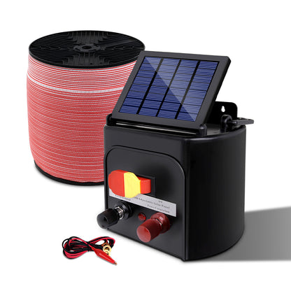 A solar-powered electric fence charging kit designed for livestock protection. It includes a Giantz Fence Energiser 5KM Solar Powered Electric 1200M Poly Tape with a black monocrystalline solar panel, red and white electric fence wire, an alligator clip electrical lead set, and a yellow and black "Shock Warning" sign. Various switches and connectors are on the charger.