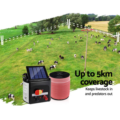 A solar-powered electric fence charging kit designed for livestock protection. It includes a Giantz Fence Energiser 5KM Solar Powered Electric 1200M Poly Tape with a black monocrystalline solar panel, red and white electric fence wire, an alligator clip electrical lead set, and a yellow and black "Shock Warning" sign. Various switches and connectors are on the charger.