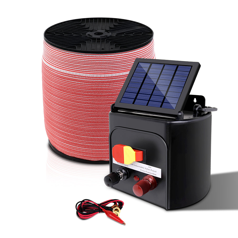 A Giantz Fence Energiser 5KM Solar Powered Electric 2000M Poly Tape is shown, featuring a monocrystalline solar panel, connectors, and a coil of red and black fencing wire. Also included are red and black alligator clips, a black grounding wire with a clip, and a yellow shock warning sign.