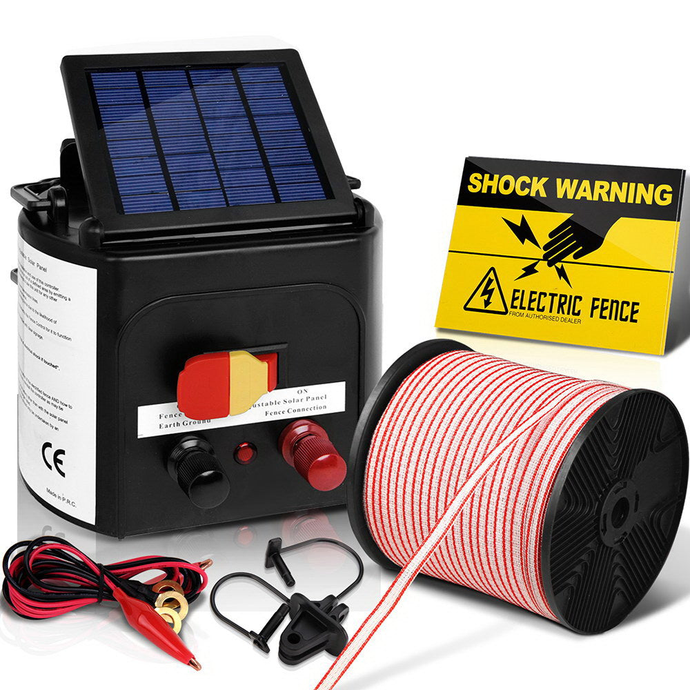 A Giantz Fence Energiser 5KM Solar Powered Electric 400M Poly Tape Insulator, featuring a black box with a solar panel on top and connectors on the front, includes a roll of red and white striped electric fence wire, warning signs, and red and black electrical clamps. Perfect for livestock containment and effective animal deterrent.