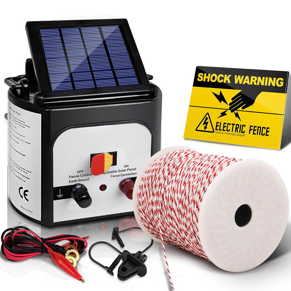 A Giantz Fence Energiser 8KM Solar Powered Electric 500M Poly Wire Insulator set on a white background designed for livestock and pet protection. The set features an 8km fence charger with a solar panel-topped energizer unit, a spool of red and white fence wire, alligator clips, a grounding stake, and a yellow "Shock Warning" sign with an electric fence symbol.