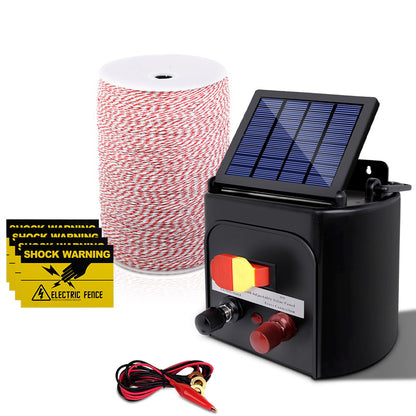 Image of a Giantz Fence Energiser 3KM Solar Powered Electric 2KM Poly Wire kit featuring a black control unit with a small solar panel on top, a large spool of red and white wire, two yellow "Shock Warning" signs with a lightning bolt graphic, and a pair of red and black alligator clips. Perfect for low maintenance livestock containment.