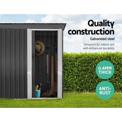 A modern, small black Giantz Garden Shed 1.62x0.86M Sheds Outdoor Storage Tool Workshop House Shelter Sliding Door with a silver-colored door and trim. Constructed from galvanized steel, it features a slanted roof and vertical ridges along the walls and door, designed for weatherproof outdoor storage. The slightly open door offers a glimpse of the interior.