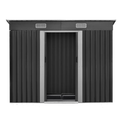 A black metal Giantz Garden Shed 2.38x1.31M w/Metal Base Sheds Outdoor Storage Tool Workshop Sliding Door with open doors reveals an array of garden tools inside. Text on the right reads "Quality construction, Strengthened galvanized steel, Designed for robust use with enhanced durability," along with labels "0.6MM THICK" and "ANTI-RUST" in green circles.