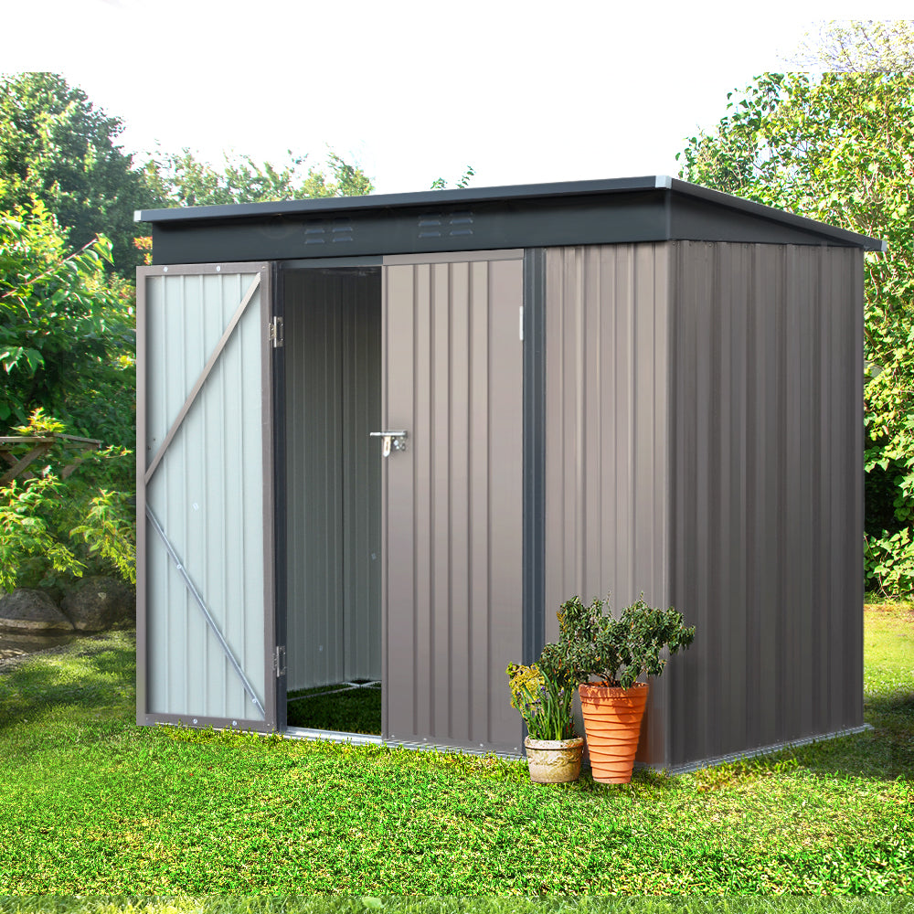 The Giantz Garden Shed 2.31x1.31M Sheds Outdoor Storage Tool Metal Workshop Shelter Double Door is a small, brown storage solution made of galvanized steel. It features a slanted roof and partially open double doors that reveal an empty interior. The shed has vertical ridges on the panels and is elevated on a framed base, with the white background highlighting its design perfectly for garden storage.