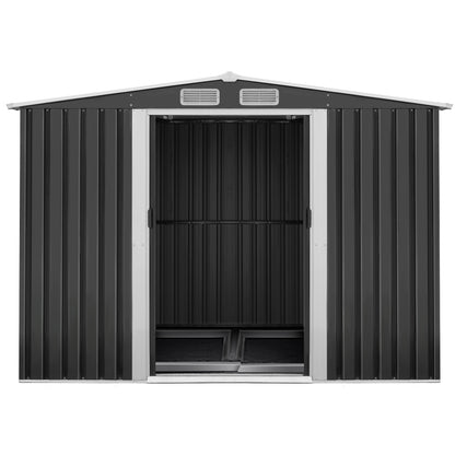 A plain black corrugated metal wall, made from galvanized steel, features a vertical ribbed pattern and a matching flat roof. The Giantz Garden Shed 2.6x3.9M w/Metal Base Sheds Outdoor Storage Workshop Tool Shelter Sliding Door facade is minimalistic and industrial, with no windows or doors visible. The entire weatherproof structure appears boxy and utilitarian, reminiscent of a metal garden shed.