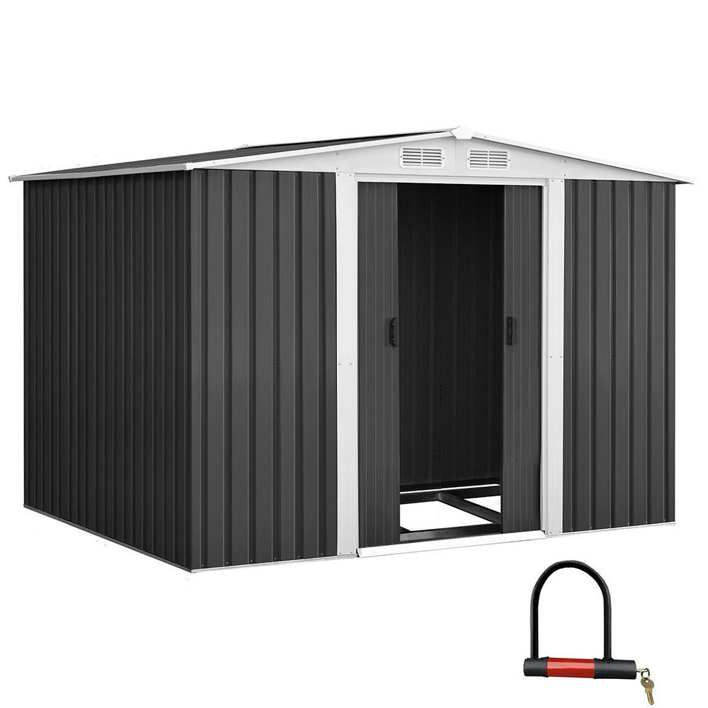 A small garden shed with its door partially open reveals garden tools inside. The text reads "Quality construction, Giantz Garden Shed 2.58x2.07M w/Metal Base Sheds Outdoor Storage Double Door Tool, designed for robust use with enhanced durability." Additional labels indicate "0.6MM Thick," "Anti-Rust," and "Galvanized steel." A green hedge is in the background.