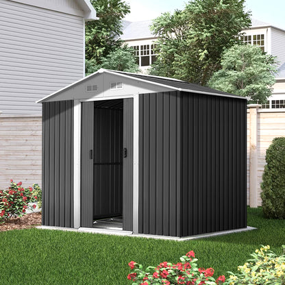 A small garden shed with its door partially open reveals garden tools inside. The text reads "Quality construction, Giantz Garden Shed 2.58x2.07M w/Metal Base Sheds Outdoor Storage Double Door Tool, designed for robust use with enhanced durability." Additional labels indicate "0.6MM Thick," "Anti-Rust," and "Galvanized steel." A green hedge is in the background.