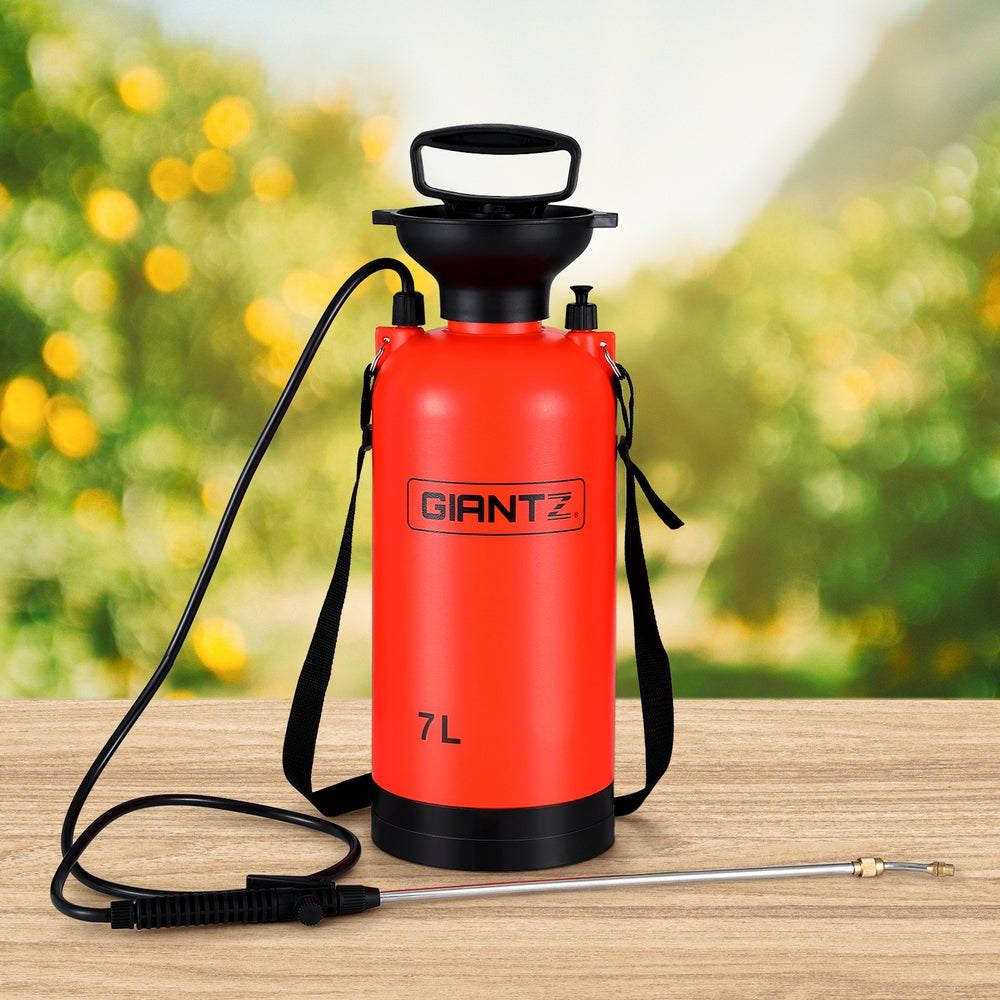 The Giantz Weed Sprayer Pressure 7L Shoulder Garden Spray, with a bright red 7L capacity tank, features a black handle and shoulder strap. It boasts a long hose attached to a black nozzle with a metal spray wand. The multi-functional garden tool includes measurements along the side for easy mixing and spraying.