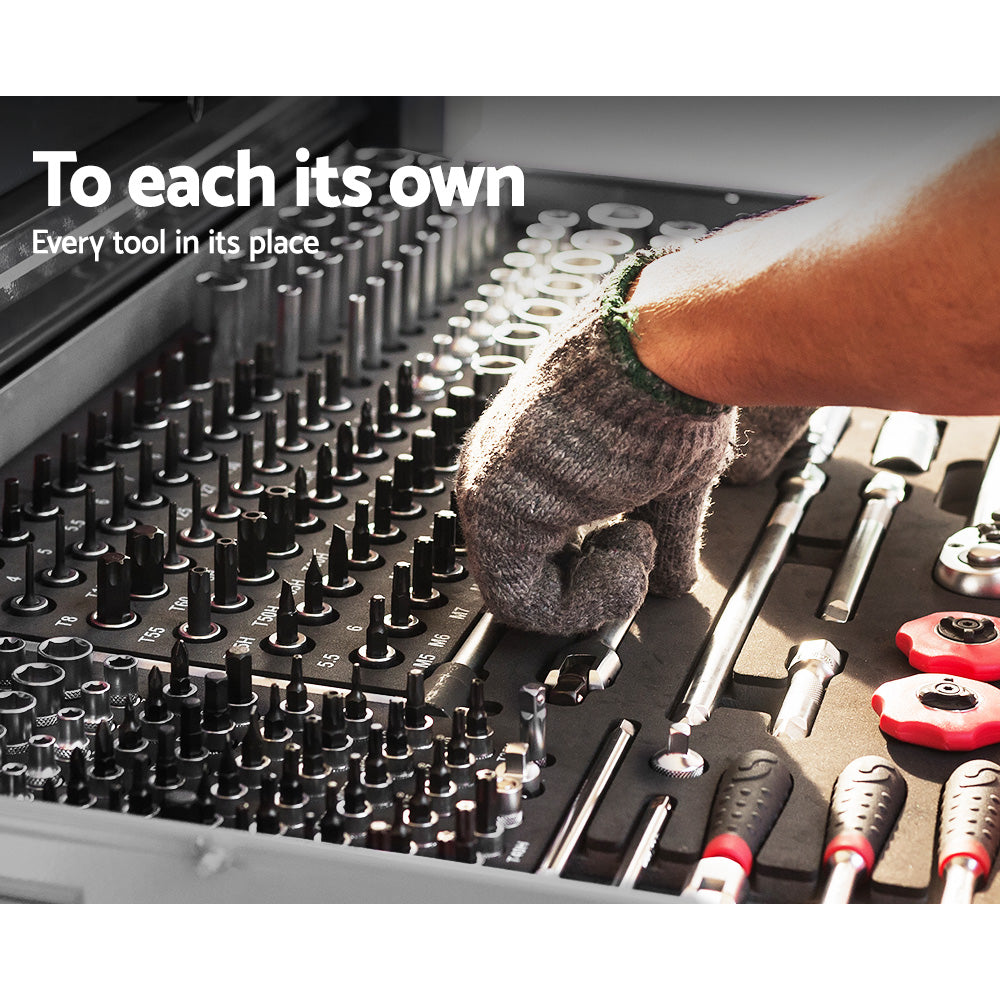 A person wearing grey gloves is organizing tools in a neatly arranged Giantz 9 Drawer Tool Box Cabinet Chest Toolbox Storage Garage Organiser Grey filled with various equipment. The text "To each its own - Every tool in its place" is displayed at the top left corner. Smooth ball-bearing slides ensure every tool has its perfect spot.