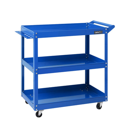 Introducing the Giantz 3-Tier Tool Cart Trolley Workshop Garage Storage Organizer Blue, a heavy-duty blue metal utility cart with three shelves and a handle on one side. Featuring four caster wheels for mobility, the top shelf includes a small tray and slots for tool organization. Sturdy construction makes it perfect for garages or workshops.