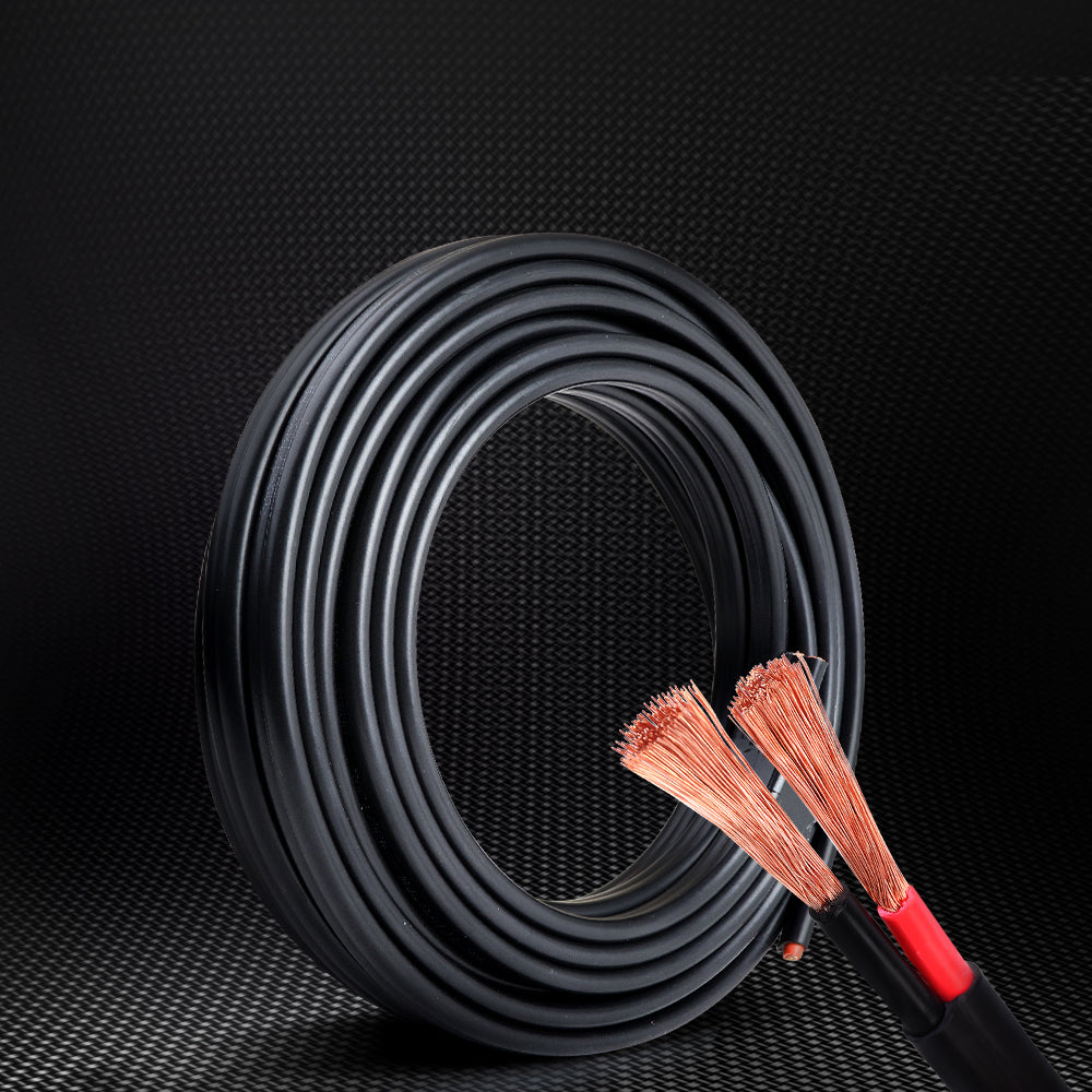 A coiled black Giantz 6MM 10M Twin Core Wire Electrical Cable Extension Car 450V 2 Sheath with a smooth surface and a small section protruding from the coil secured with a black strap. The cable, featuring an oxygen-free copper core, has a contrasting orange tip at one end. The overall appearance is neat and tightly wound.