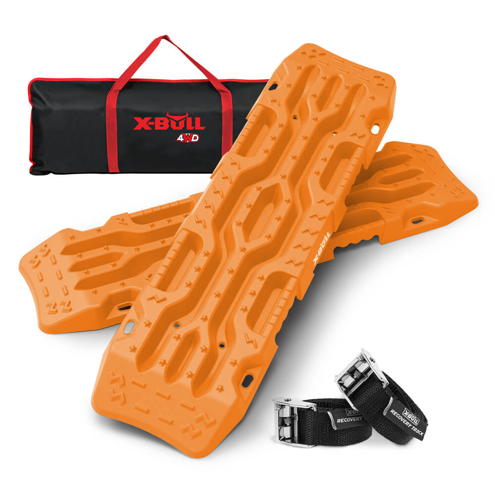 Two bright orange X-BULL 4X4 Recovery tracks Boards Sand tracks Snow Mud 2PCS 12T 4WD Car Truck New are stacked against each other, featuring rugged and textured surfaces for unparalleled grip. They are accompanied by two black straps with silver buckles labeled "RECOVERY." A black and red carrying bag with the "X-BULL 4WD" logo is seen in the background, ideal for off-road use.