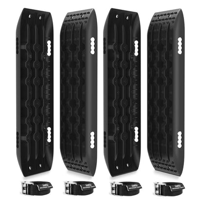 This image shows four X-BULL Recovery Tracks Gen 2.0 10T Sand Mud Snow 2 Pairs Offroad 4WD 4x4 2PC 91CM Black designed for off-road vehicle recovery. The boards feature a rugged, textured surface for enhanced grip and a cruciform design for added strength. Below the boards are three black straps with buckle fasteners, likely for securing the tracks when not in use.