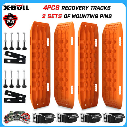 The image displays a recovery tracks set by X-BULL 4WD Recovery tracks 10T 2 Pairs/ Sand tracks/ Mud tracks/ Mounting Bolts Pins Gen 2.0, featuring four bright orange recovery tracks made from a durable nylon mixture and two sets of mounting pins. Also shown are related accessories such as bolts, washers, mounting brackets, and securing straps. The text highlights "4PCS Recovery Tracks" and "2 Sets of Mounting Pins.