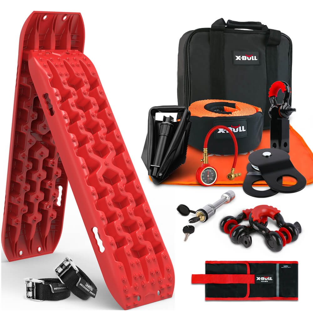 A collection of off-road recovery gear includes the X-BULL Recovery Kit 4WD Winch Recovery kit Snatch Strap Recovery Tracks Gen3.0 Red, a black storage bag with "X-BULL" branding, a tow strap, a tire deflator, a pair of red shackles, a snatch block, an air compressor with a high pressure air pump nozzle, and other recovery accessories.