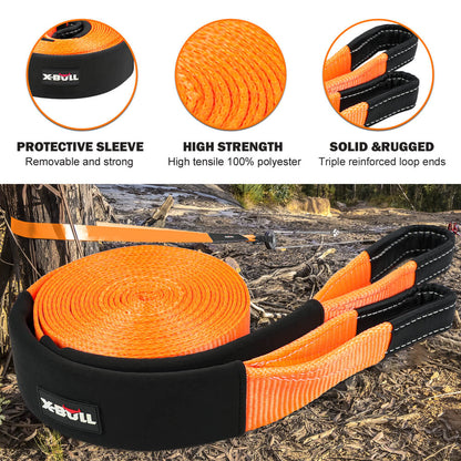 An orange heavy-duty recovery strap with black reinforced covers, black shackles, and a black snatch ring, all branded with "X-BULL." The X-BULL 4WD Recovery Kit Off Road Snatch Strap Soft Shackles Snatch Block Pulley includes a black carry bag and is displayed with its packaging box labeled "Heavy-Duty Recovery Gear." Perfect for your off-roading kit.