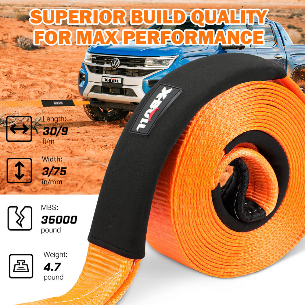 An orange heavy-duty recovery strap with black reinforced covers, black shackles, and a black snatch ring, all branded with "X-BULL." The X-BULL 4WD Recovery Kit Off Road Snatch Strap Soft Shackles Snatch Block Pulley includes a black carry bag and is displayed with its packaging box labeled "Heavy-Duty Recovery Gear." Perfect for your off-roading kit.