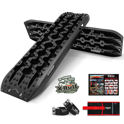 A pair of black X-BULL Recovery tracks / Sand tracks / Mud tracks / Off Road 4WD 4x4 Car 2pcs Gen 3.0 - Black, designed with reinforced strong nylon and a 10-ton load capacity, are displayed—one lying flat and the other propped on top. The image also includes a carrying case, two straps, and a promotional sheet highlighting other products. X-Bull branding is visible on all items.