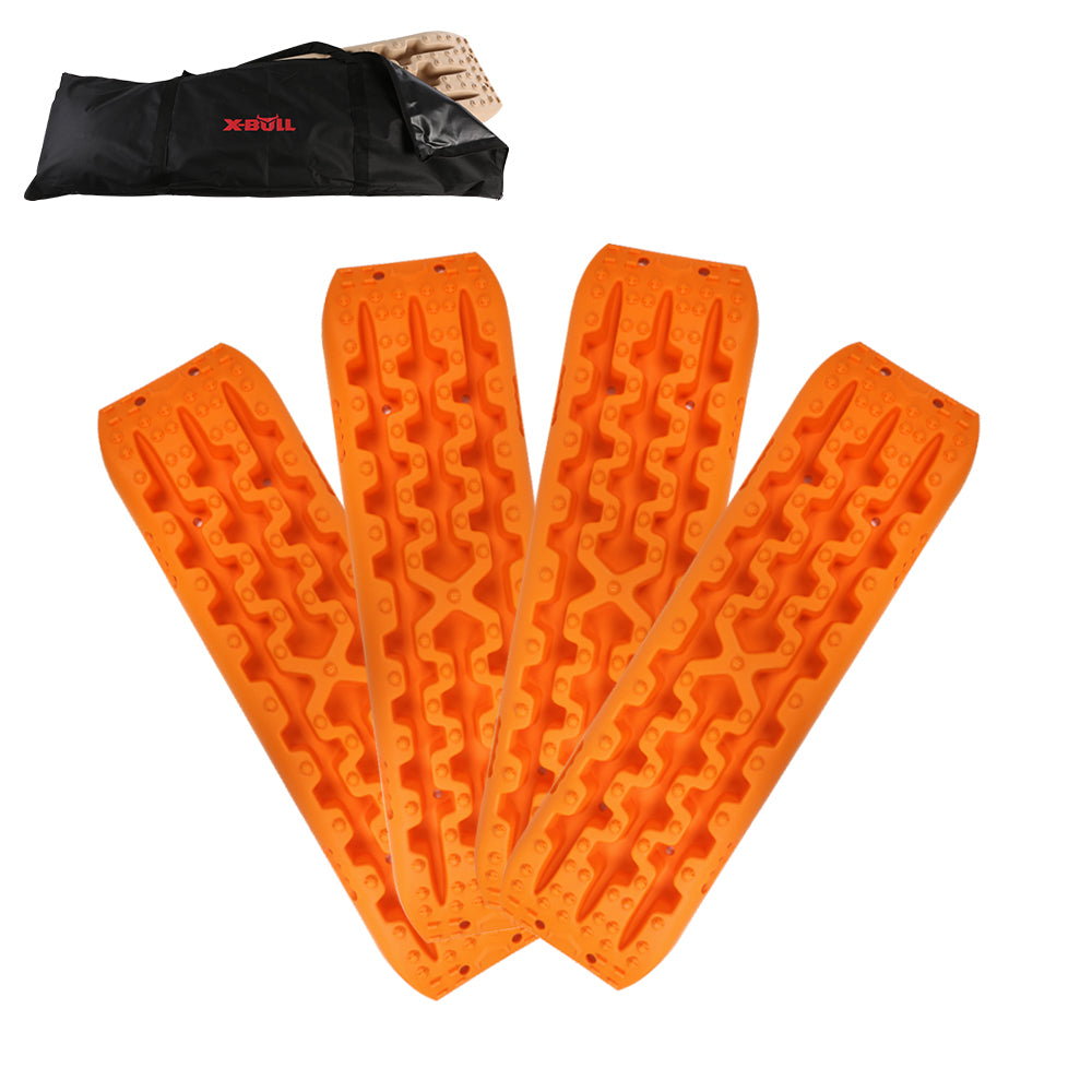 Four bright orange traction boards, made from reinforced strong nylon, are arranged in a fan shape with a carrying bag in the background. These X-BULL Recovery tracks Sand 2 Pairs 4PC10T 4WD Sand / Snow / Mud Off-road Gen 3.0 have a rugged surface designed to provide grip for vehicle tires in off-road or slippery conditions and support up to a 10 ton load capacity.