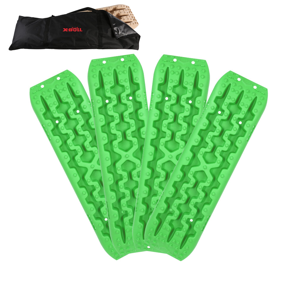 Four X-BULL Recovery tracks Sand tracks 2 Pairs Sand / Snow / Mud 10T 4WD Gen 3.0 - Green, designed with reinforced strong nylon for durability, are arranged in a fan shape for off-road vehicle recovery. They feature textured surfaces for grip and can handle up to a 10 Ton load capacity. A black carrying bag with a red "X-BULL" logo is shown in the top left corner.