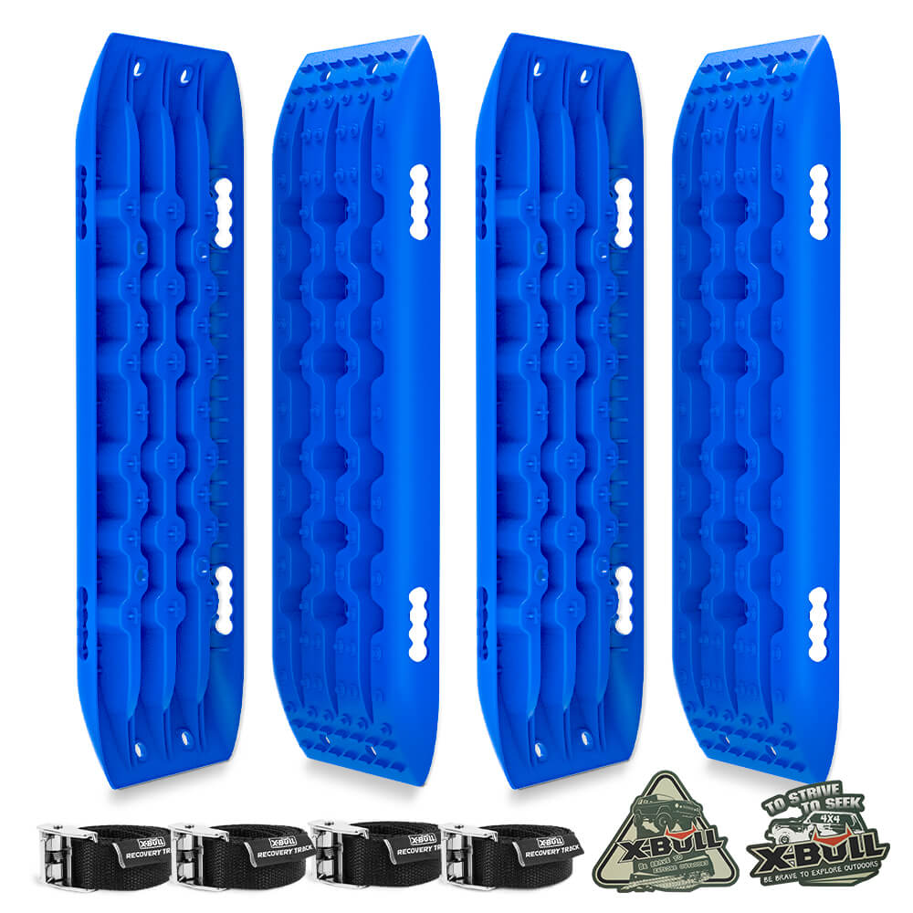 The image shows three bright blue X-BULL Recovery tracks Sand tracks 2 pairs Sand / Snow / Mud 10T 4WD Gen 2.0 - blue, each with a textured surface for grip made from durable nylon material. Below them are four black straps with metal clasps. On the right side, there are two badges: one reads "X-Bull," and the other reads "10 Stake Tire Spike" in U-shape design.