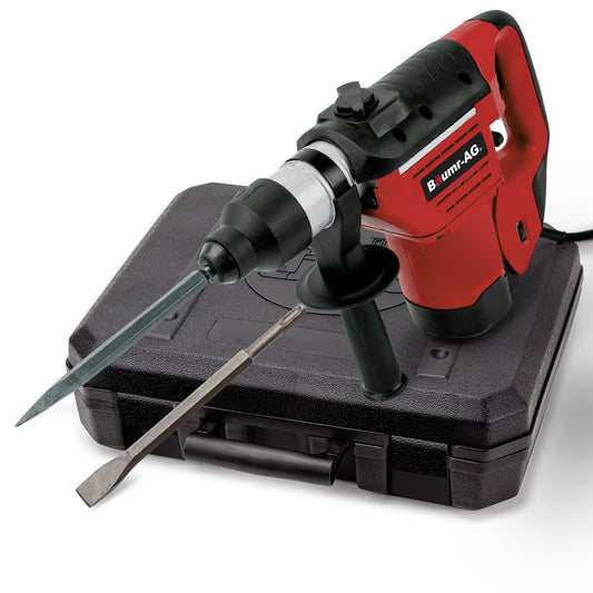 A red and black electric Baumr-AG 1500W Pro-Grade Electric Rotary Jackhammer Hammer Drill, with 2 Bonus Chisels, 3 Drill Bits is positioned atop a black carrying case. A flat chisel bit lies next to the jackhammer, ready for use. This powerful tool features a side handle for additional grip and control.