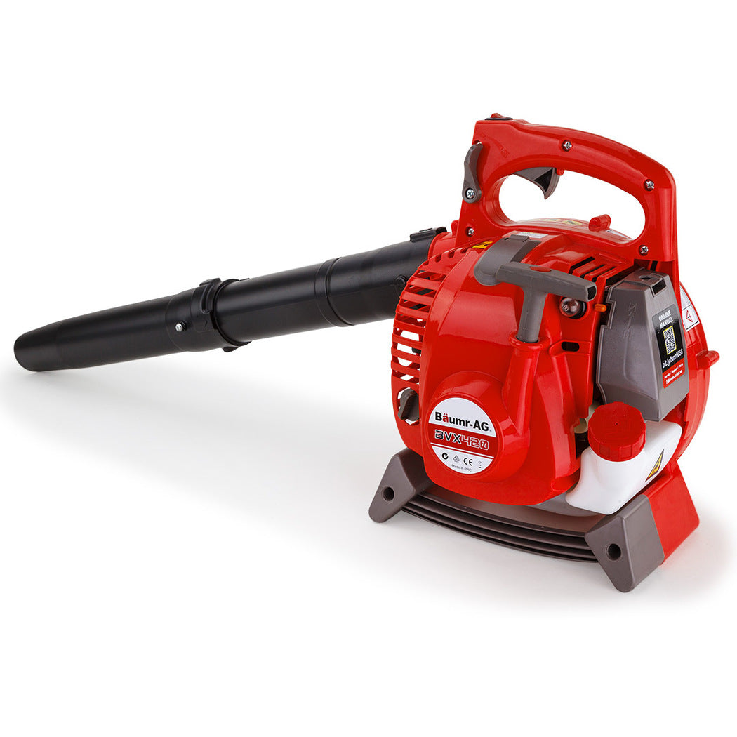 A red "Baumr-AG Petrol Leaf Blower Vacuum 4 Stroke - Vac Garden Commercial Hand Outdoor" with black nozzle and handle features control buttons, a fuel tank, safety labels, and an air vent. This 4-stroke blower boasts a low-emissions engine and stands on a supportive base with a curved design for stability.