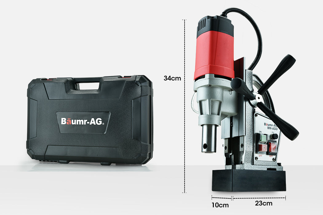 A heavy-duty industrial tool, the Baumr-AG Annular Cutter Magnetic Core Hole Drill Press Machine Metal Drilling features a silver and red motor, black handle grips, and a control panel with on/off switches. Mounted on a black base, it has wires extending from the top and side to connect components—ideal for steel fabrication tasks.