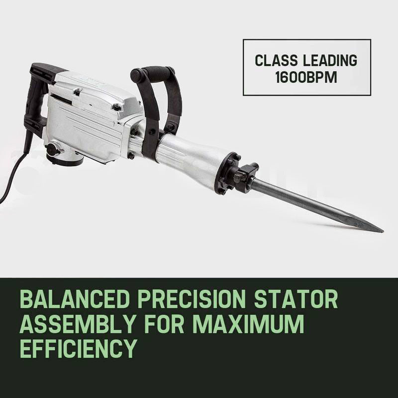 A Baumr-AG 2200W JackHammer Commercial Grade Demolition Jack Hammer Concrete with two chisel attachments lies on top of a closed green metal toolbox. Commercial grade and designed for demolition works, the jackhammer boasts a metallic finish with black accents and an attached electrical cord. The chisel attachments are placed parallel to the toolbox.