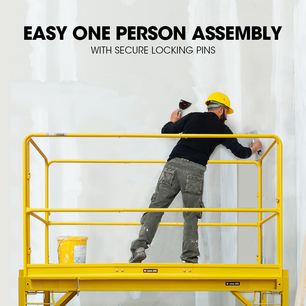 A yellow, rectangular Tradie's Mate Baumr-AG Safety Guard Rail for Adjustable Mobile Scaffold enclosure designed for an elevated platform or mobile scaffolds. Made from powder-coated steel, the railing features multiple horizontal bars and a gate for access, ensuring fall protection and security. The platform and lower structure are partially visible.