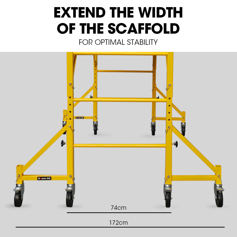 The Baumr-AG Scaffold is a yellow mobile scaffolding unit with four wheels and safety locking mechanisms. The platform is elevated and supported by sturdy metal frames and adjustable braces, making it suitable for construction or maintenance work at height, especially when paired with the Baumr-AG Outrigger Wheel Set for Adjustable Mobile Scaffolding, 4pc.