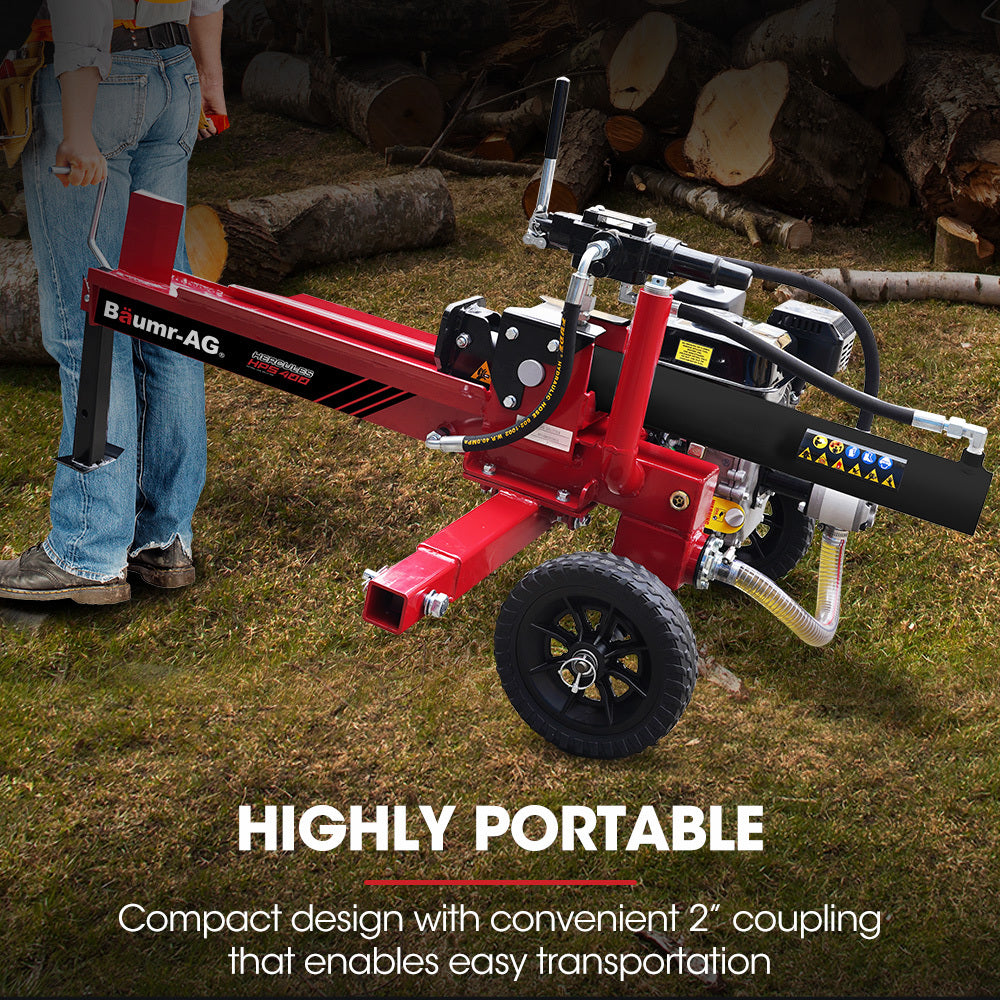 A red Baumr-AG 12 Tonne Petrol Hydraulic Wood Log Splitter - HPS400 is shown. The machine, equipped with a powerful 4-stroke engine, is mounted on two black wheels for mobility, with a control lever and tank. The splitting wedge is positioned at the front end, ready for use.