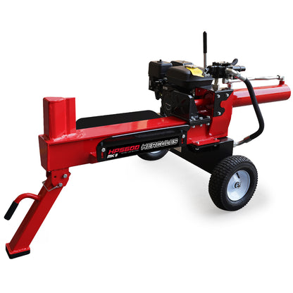 A red Tradie's Mate Baumr-AG 20 Tonne Hydraulic Petrol Log Splitter 8HP Towed Wood Firewood Cutter - HPS600 boasts a powerful 20 tonnes splitting force with two black wheels, a black engine on top, a lever for operation, and a sturdy metal frame. The splitter features an extended red arm for loading logs and a black handle for maneuverability.