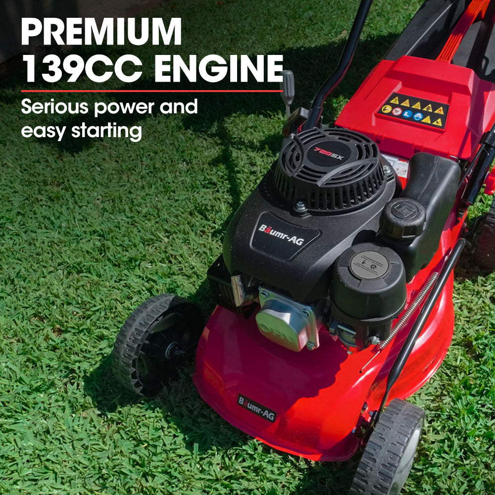 A red and black Baumr-AG Lawn Mower 139CC 17 Petrol Push Lawnmower 4-Stroke Engine Catch with four wheels, a black handle, and a grass collection bag attached at the back. The Baumr-AG 720SX boasts a 139cc engine mounted on its deck, with the brand name "AG" visible on the side.